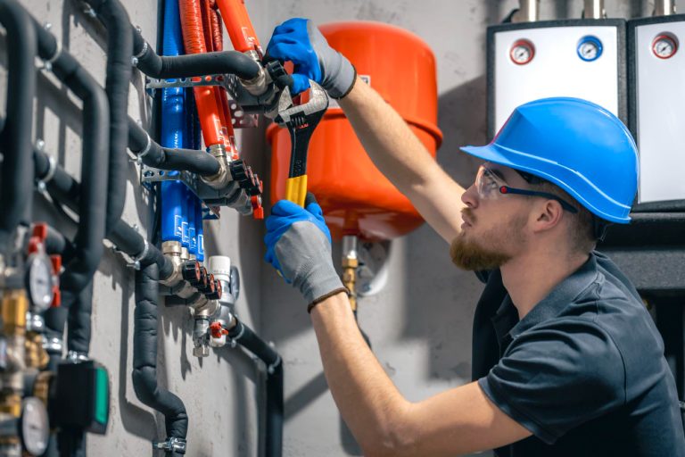 Heating repair โ technician servicing heating system piping